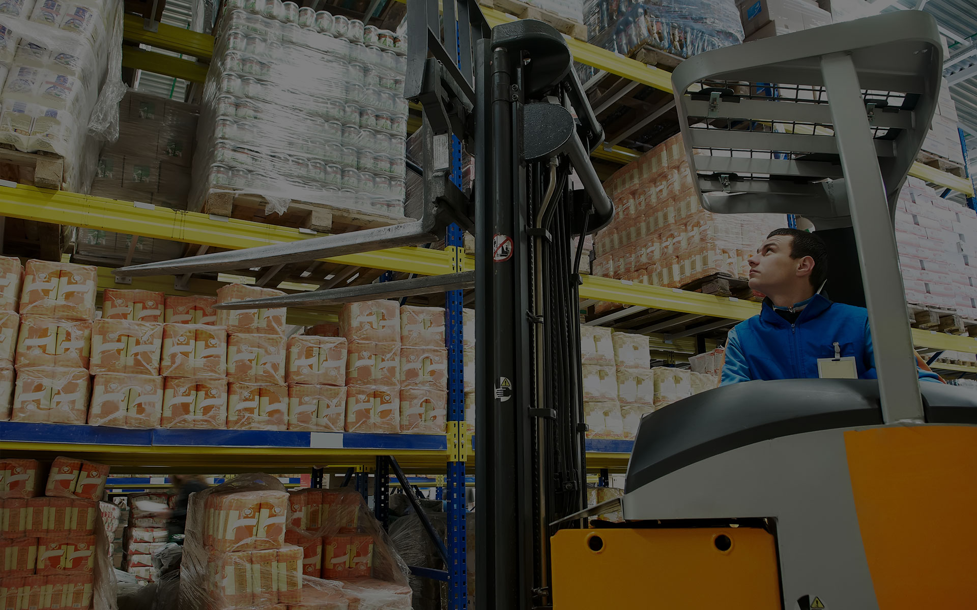 forklift operator in warehouse stocking shelves