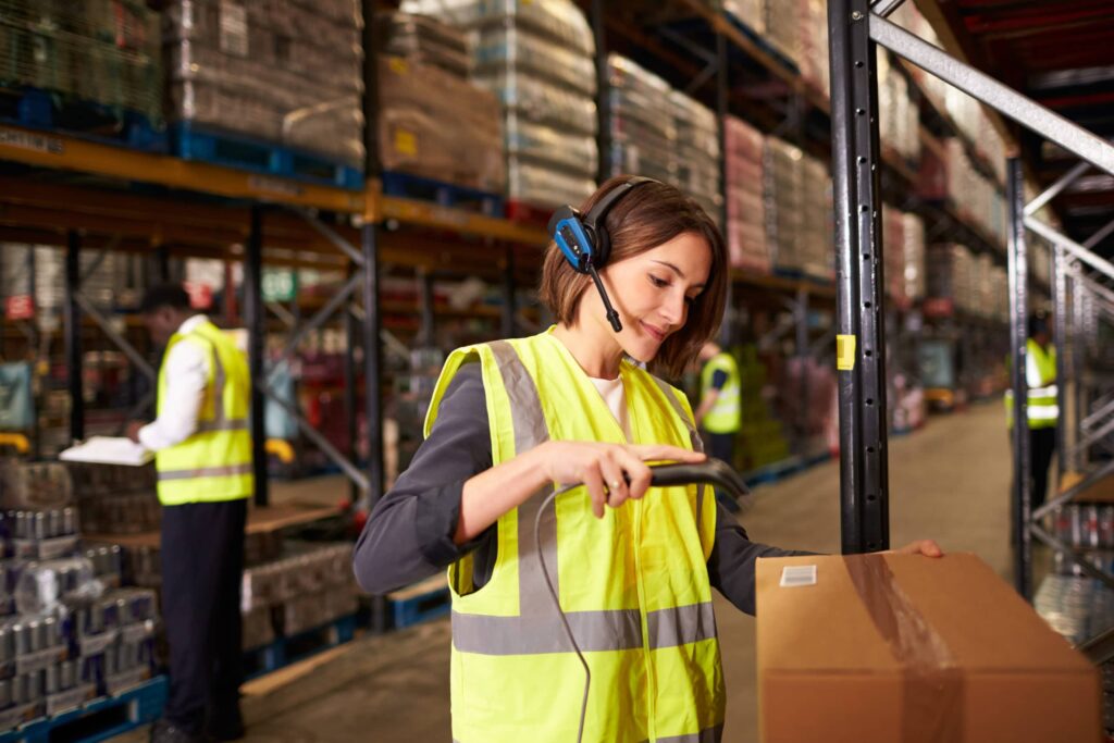 Woman scanning packages in warehouses